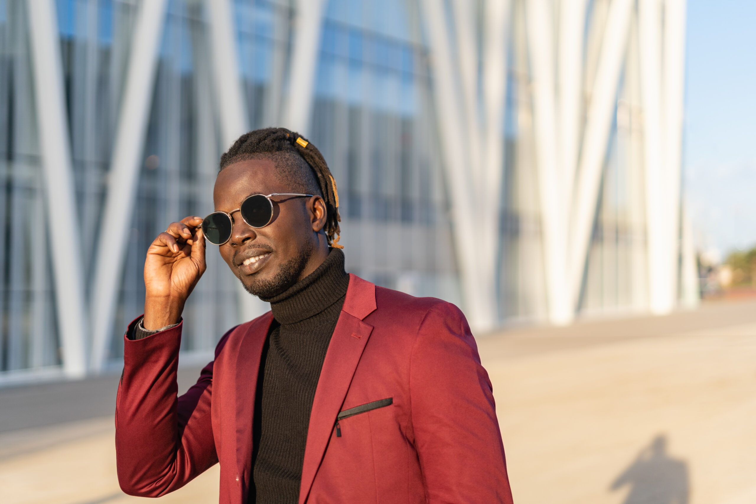 Portrait of businessman wearing sunglasses and suit in city