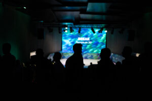 Corporate event photography in Barcelona showing attendees at a business presentation
